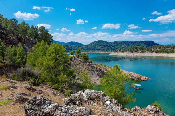 istock Beautiful Karacaoren turkish lake with mountains and cloudy sky reflections 1347030991
