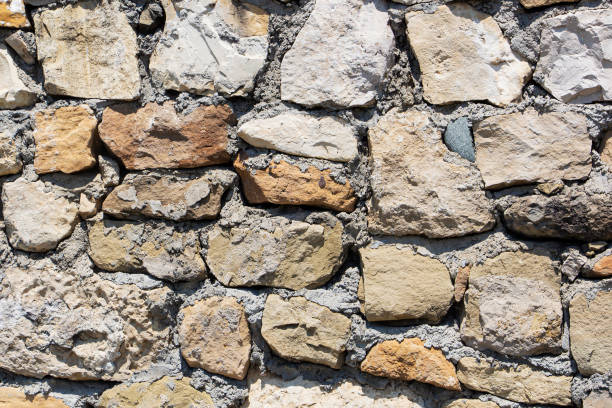 istock The rough textured surface of the wild stone wall. Background. 1347031005