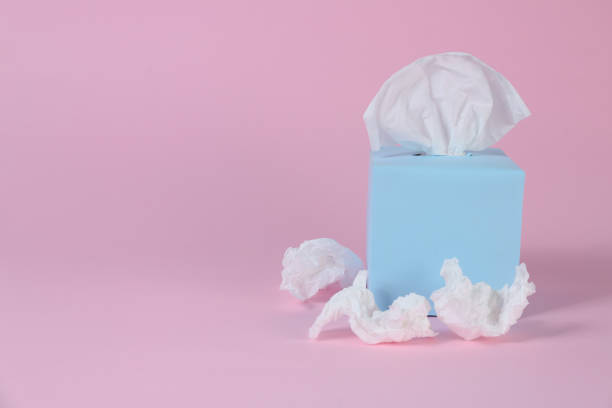 istock Box with paper tissues and used crumpled napkins on pink background, space for text 1347031199