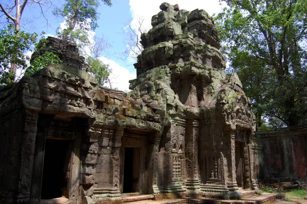 Tree roots and Ancient ruins antique building Prasat Ta Prohm or Ancestor Brahma temple of Angkor Wat for Cambodian people travelers travel visit respect praying at Angkor Thom in Siem Reap, Cambodia