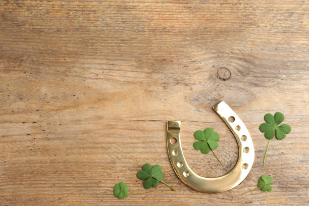 istock Clover leaves and horseshoe on wooden table, flat lay with space for text. St. Patrick's Day celebration 1347031367