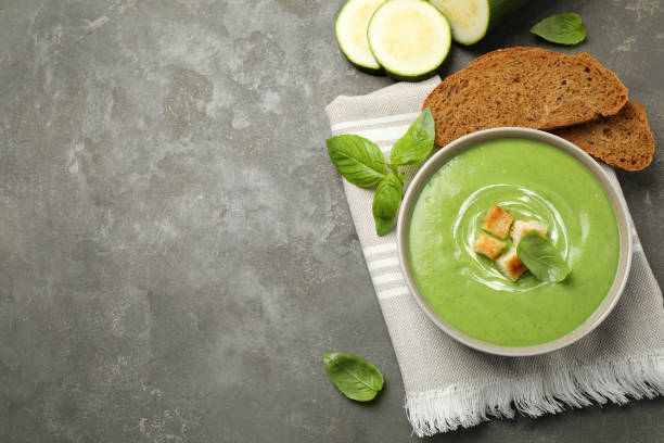 istock Tasty homemade zucchini cream soup served on grey table, flat lay. Space for text 1347031490