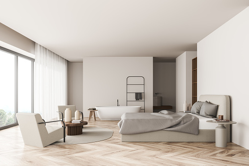 Bright bedroom interior with large bed, two armchairs, carpet, bathtub, coffee table and oak wooden parquet floor. Concept of scandinavian minimalist design for chill and relaxation. 3d rendering