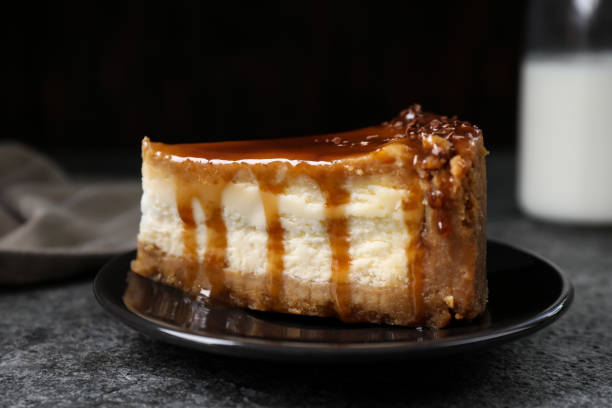istock Piece of delicious cake with caramel served on grey table 1347032688