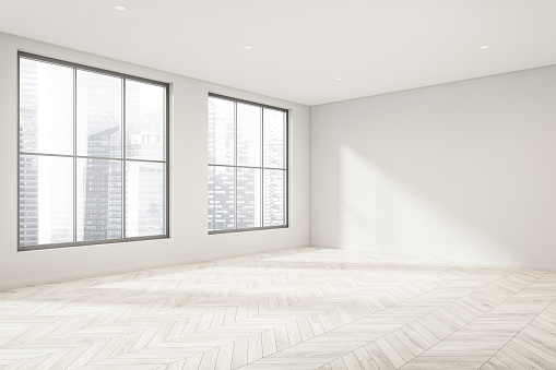 Corner of empty living room interior with white walls, the lack of furniture and wood-look parquet flooring. A concept of modern apartment design. 3d rendering