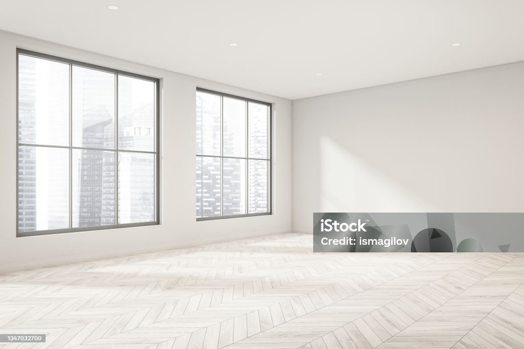 Empty white room with light wood floor and windows. Corner view. Corner of empty living room interior with white walls, the lack of furniture and wood-look parquet flooring. A concept of modern apartment design. 3d rendering Empty Stock Photo