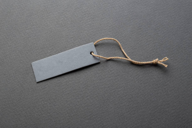 Clothing tag, label blank mockup template on a paper background. Price tag, gift tag, sale tag.