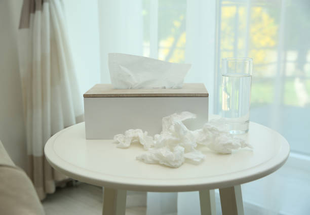 istock Used paper tissues, holder and water on table indoors 1347033566