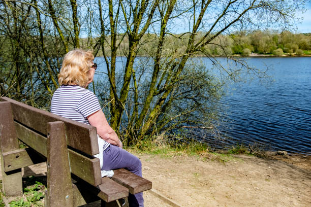 istock Woman Relaxing On A Lakeside Bench 1347034440