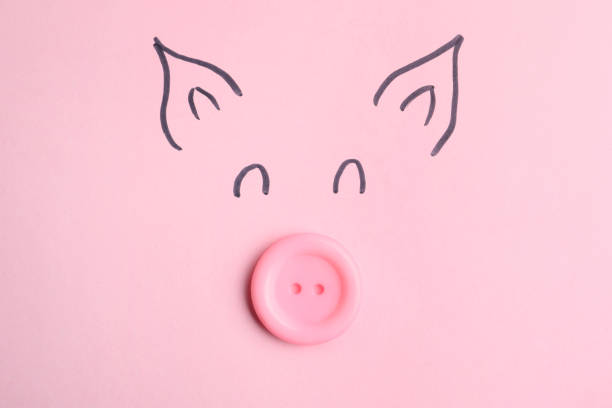 Piggy face with sewing button on pink background, top view