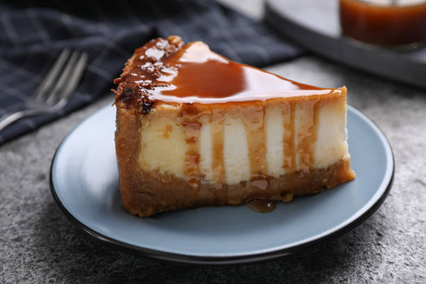 istock Piece of delicious cake with caramel served on grey table 1347034703