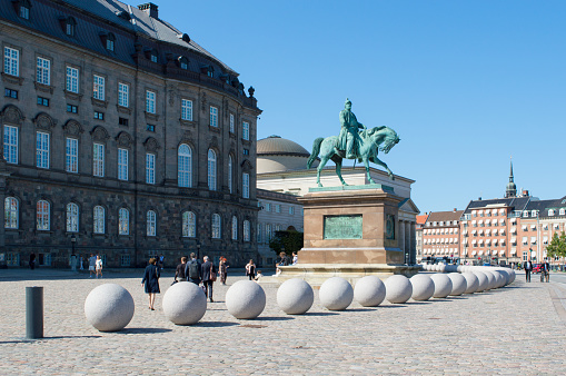 Copenhagen, Denmark - 02 Sep 2021: Bronze statue of Danish king Frederik VII in front of Christiansborg Palace, danish parliament building