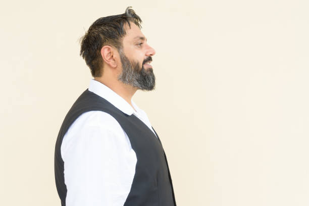 istock Profile view portrait of handsome bearded Indian man against plain background 1347039638