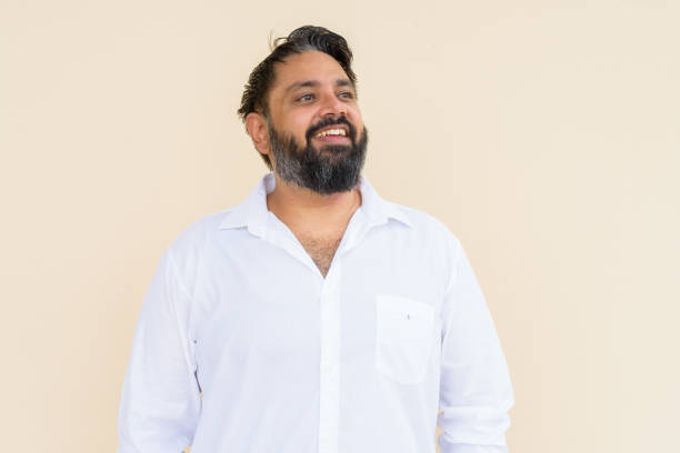 istock Portrait of handsome bearded Indian man against plain background 1347039850
