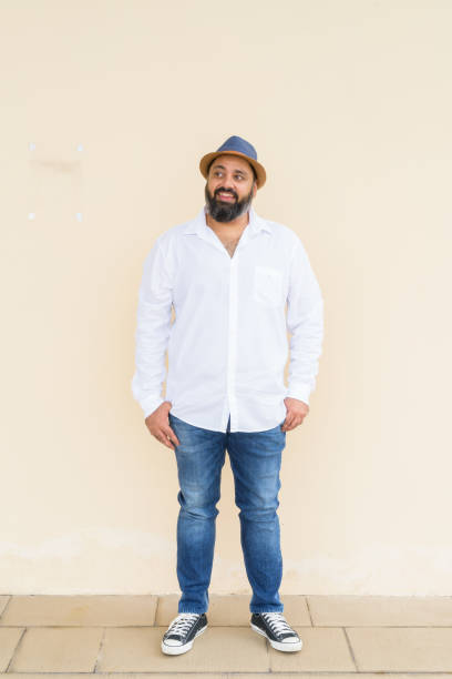 istock Portrait of handsome bearded Indian man against plain background 1347039861