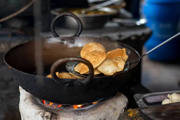 Frying kachori in a Frying Pan at a street food stall in Kolkata.