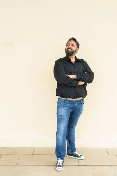 istock Portrait of handsome bearded Indian man against plain background 1347039945