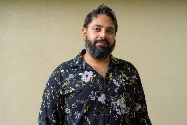 istock Portrait of handsome bearded Indian man against plain background 1347040038
