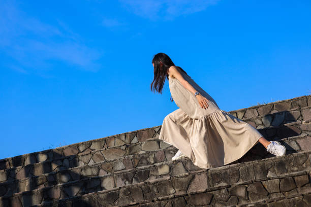 istock Beautiful woman dancing against sky on beach 1347040613