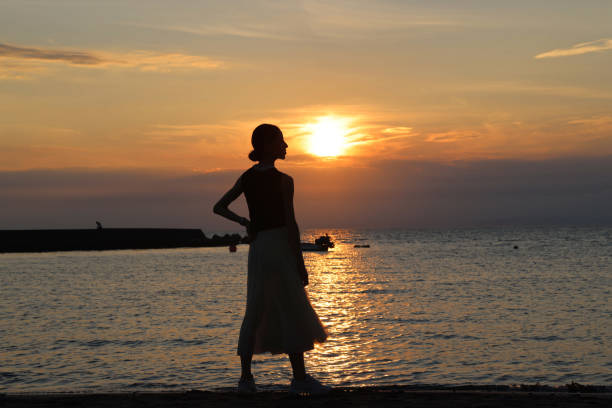 istock Beautiful woman relaxing  on beach during Sunset 1347040853
