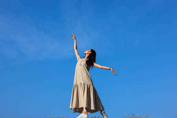 istock Beautiful woman dancing on beach 1347041062