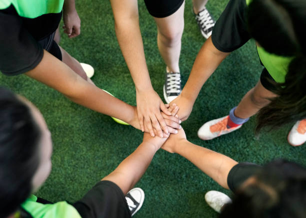 istock Soccer players are stacking hands in training ground 1347043993