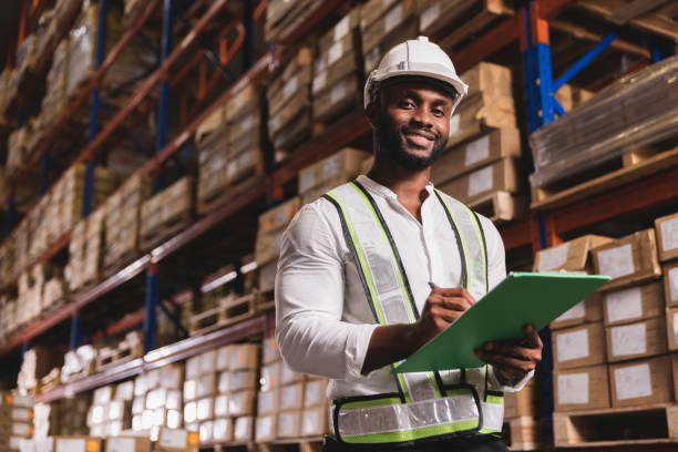 istock Black male staff smiling working check stock in distribution  logistic warehouse 1347044213