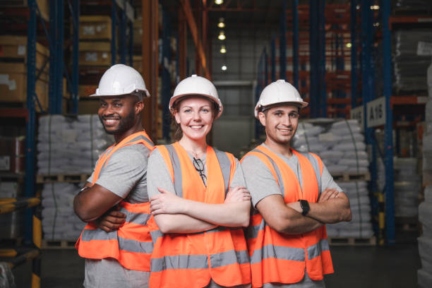 istock Group of smiling worker standing together at logistic distribution warehouse, Teamwork concept 1347044270