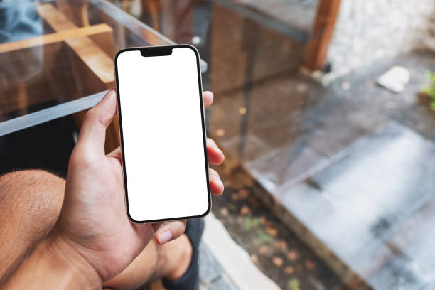 istock a man holding mobile phone with blank white screen in cafe 1347044885