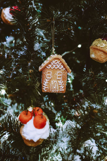 istock Gingerbread house hanging on the Christmas tree. Nostalgic Christmas decoration. 1347046610