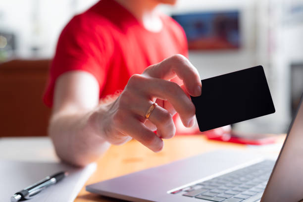 istock a man holding a small black card without text 1347047390