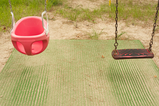 an empty swing on a playground