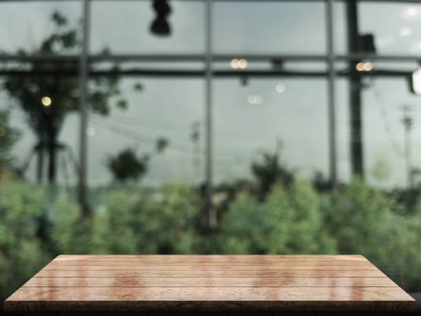 istock Empty wooden table top with lights bokeh on blur restaurant background 1347047618