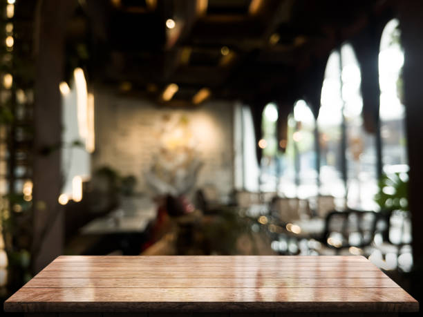 istock Empty wooden table top with lights bokeh on blur restaurant background 1347047621