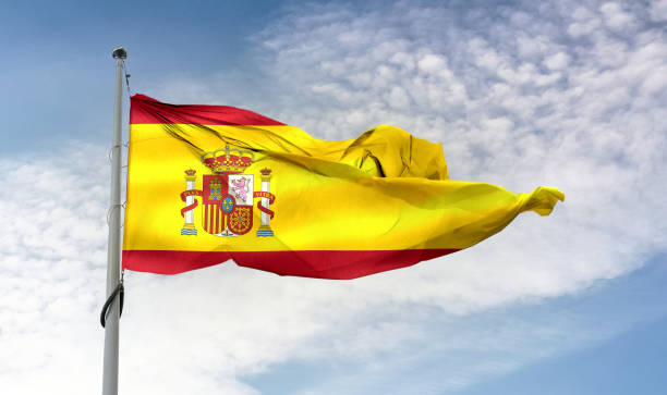 istock Spain flag - realistic waving fabric flag 1347048489