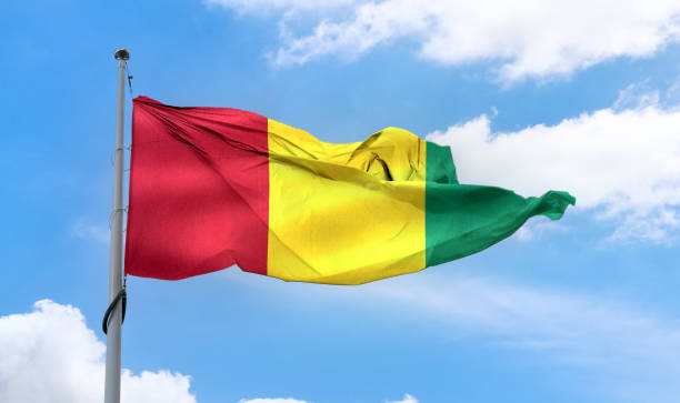 istock Guinea flag - realistic waving fabric flag. 1347048567