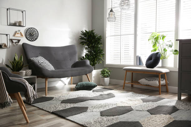 istock Stylish grey sofa in modern living room interior 1347048928