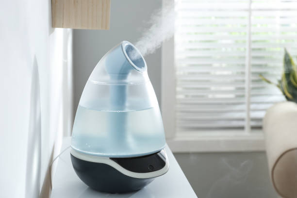 istock Modern air humidifier on table at home. Space for text 1347048930
