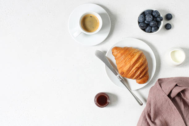 istock Breakfast with espresso, croissant, jam and berries on a white background top view, copy space 1347049006