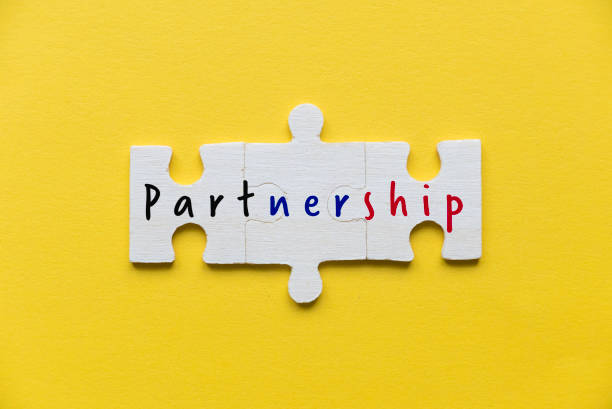istock Top view of three puzzle pieces with word partnership. 1347049042