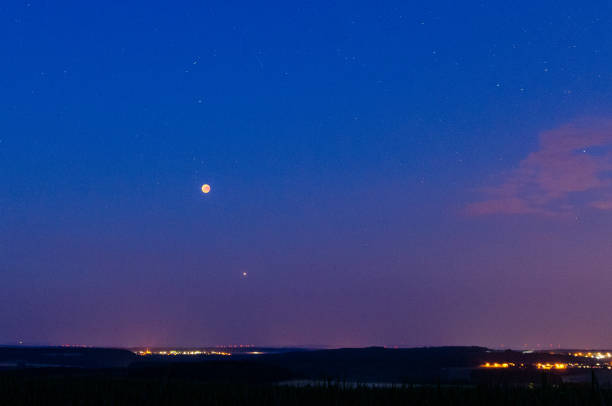 istock red moon of the total lunar eclipse with mars under a rural eifel landscape on July 27, 2018, Germany 1347049088