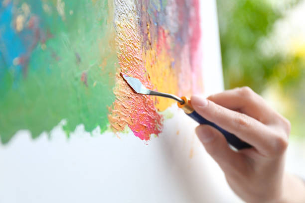 istock Artist painting on canvas with spatula, closeup 1347049723