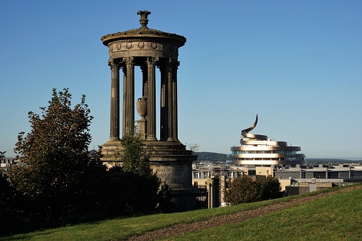 Edinburgh, Scotland - 15 October 2021: Looking past the Dugald Stewart monument towards the swirly metallic \