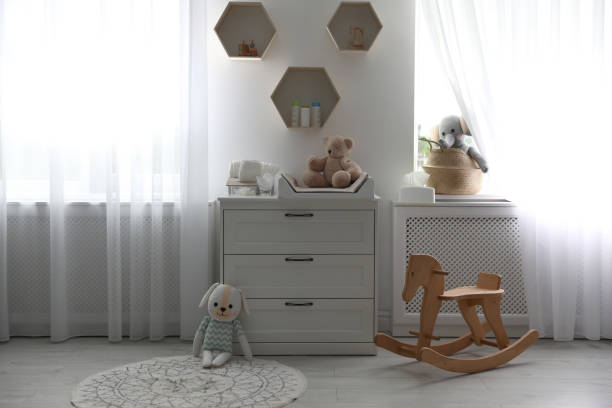 istock Beautiful baby room interior with toys and modern changing table 1347051186
