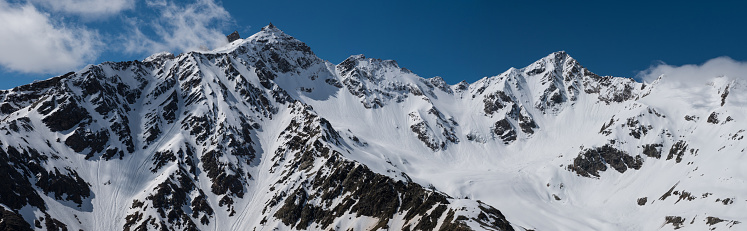 A panorama photo of Hoverla mountain with snow on it. View from above of Carpathian mountains