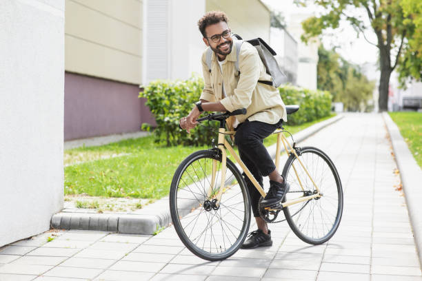 istock Handsome young man with bicycle in a city 1347056021