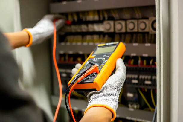 istock Electrician engineer uses a multimeter to test the electrical installation and power line current in an electrical system control cabinet. 1347059281