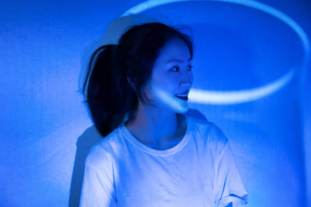 istock The young woman in white was illuminated by blue lights 1347059314
