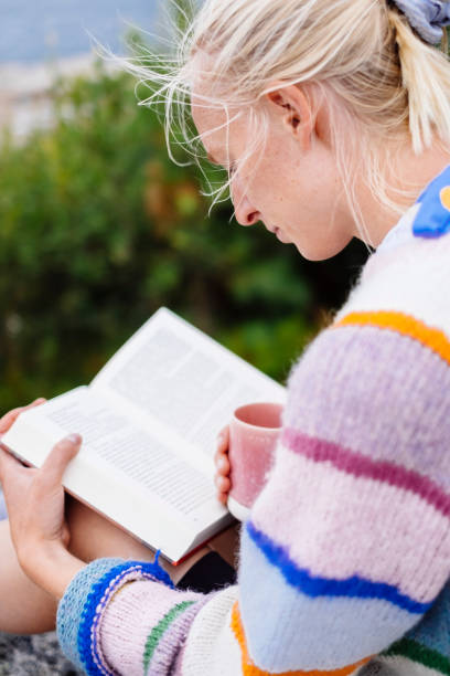 istock Woman reading a novel on a mountain top 1347060665