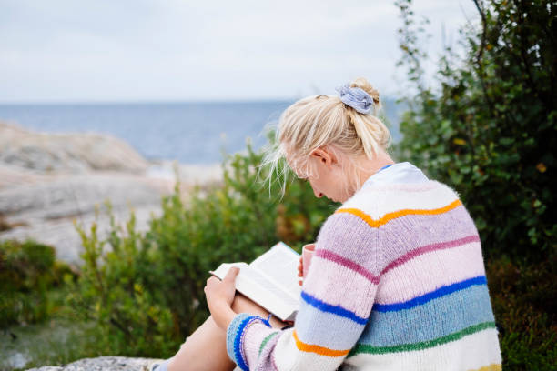 istock Woman reading her book outside in nature 1347060857